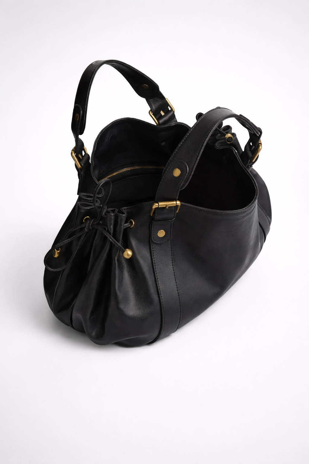 Black leather handbag with gold accents on a white background