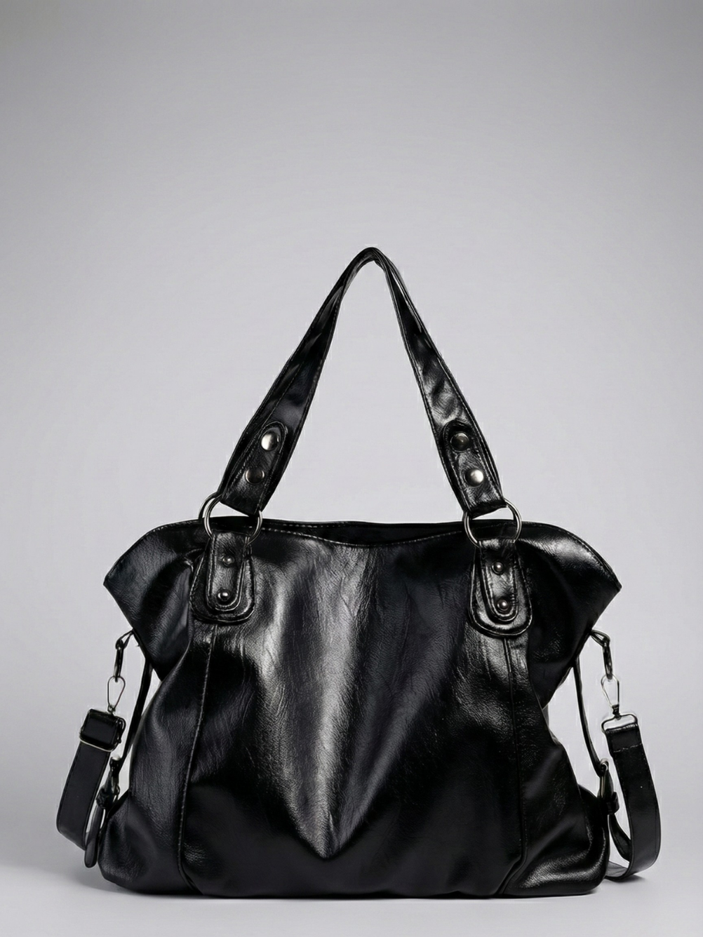 Black leather handbag on a gray background