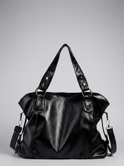 Black leather handbag on a gray background