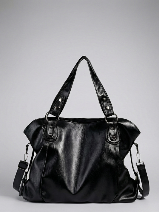 Black leather handbag on a gray background