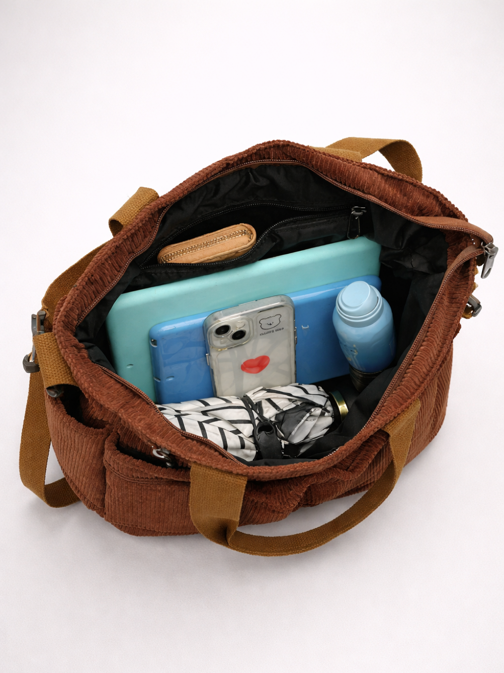 Brown bag with items inside on a white background