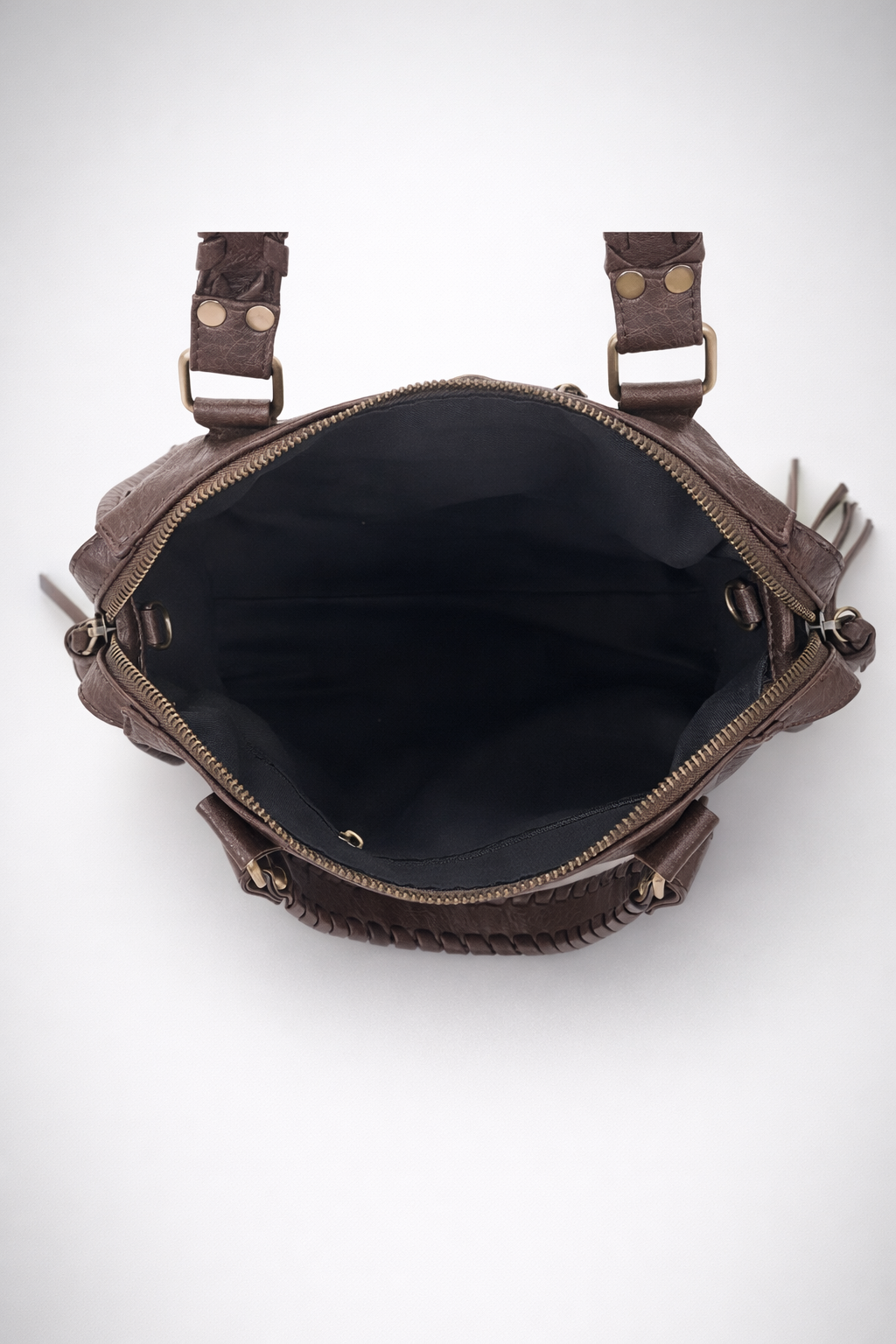 Brown leather bag with visible stitching on a white background