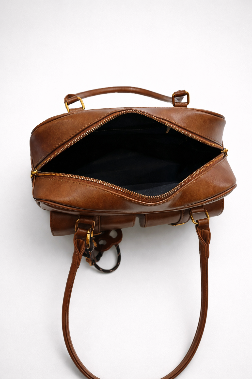 Brown leather bag with open top on a white background