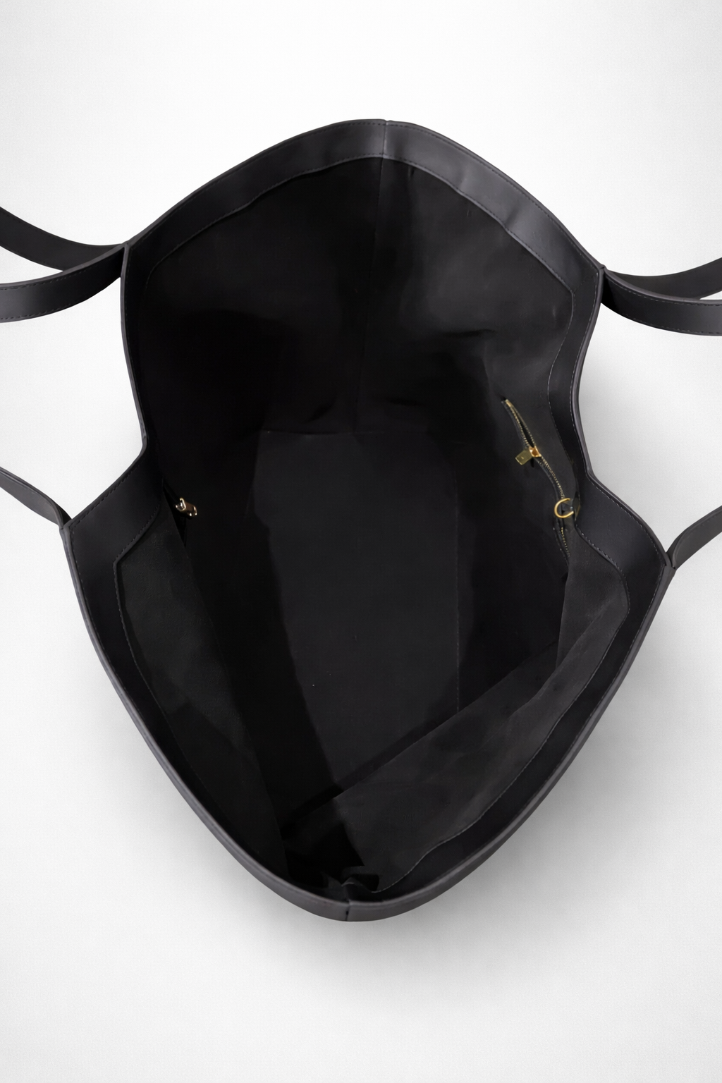 Black handbag with gold accents on a white background